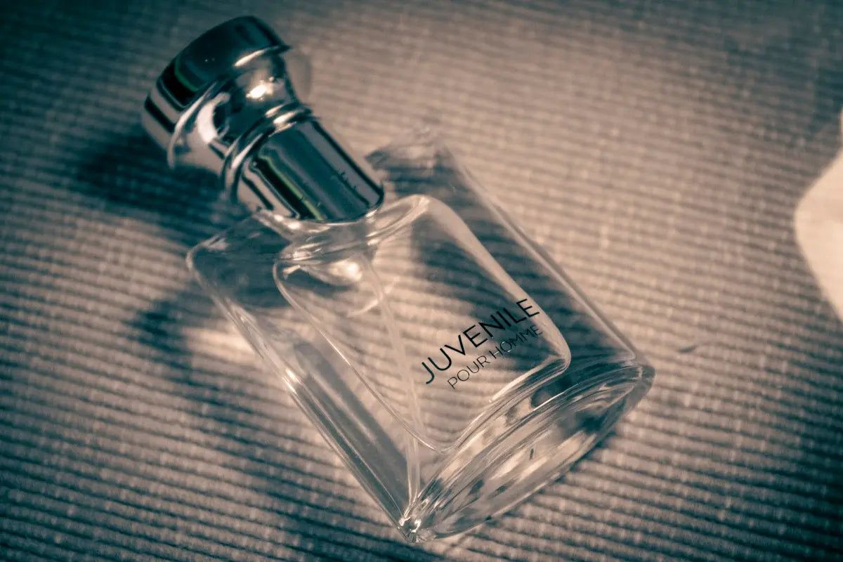 a bottle of perfume sitting on top of a bed