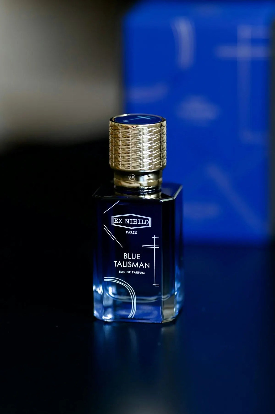 a bottle of blue taliskman on a table